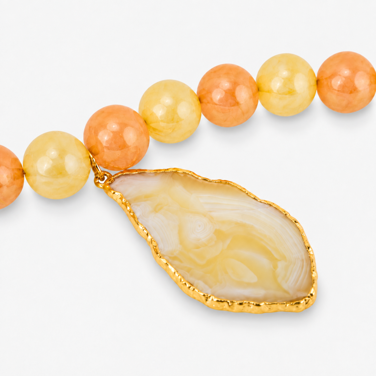Sassy Jones Lemon Sorbet statement necklace featuring chunky citrus colored beads and a large sliced agate centerpiece.