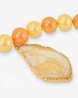 Sassy Jones Lemon Sorbet statement necklace featuring chunky citrus colored beads and a large sliced agate centerpiece.