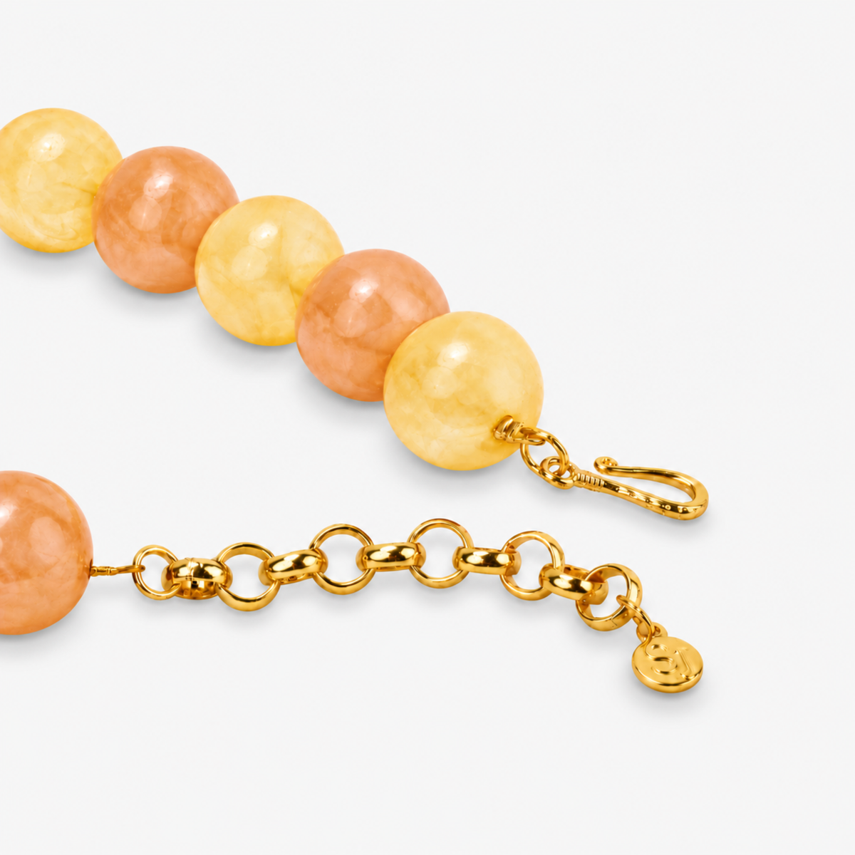 Chunky beaded necklace featuring soft yellow, peach, and cream tones with a large natural stone pendant.

Chrysallis Necklace Lemon Sorbet featuring round marbled beads, organic stone patterning, and a statement agate drop.