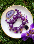Three piece stretch bracelet stack featuring genuine purple agate beads, a natural druzy agate slice, crystal charms, gemstone accents, and gold detailing.