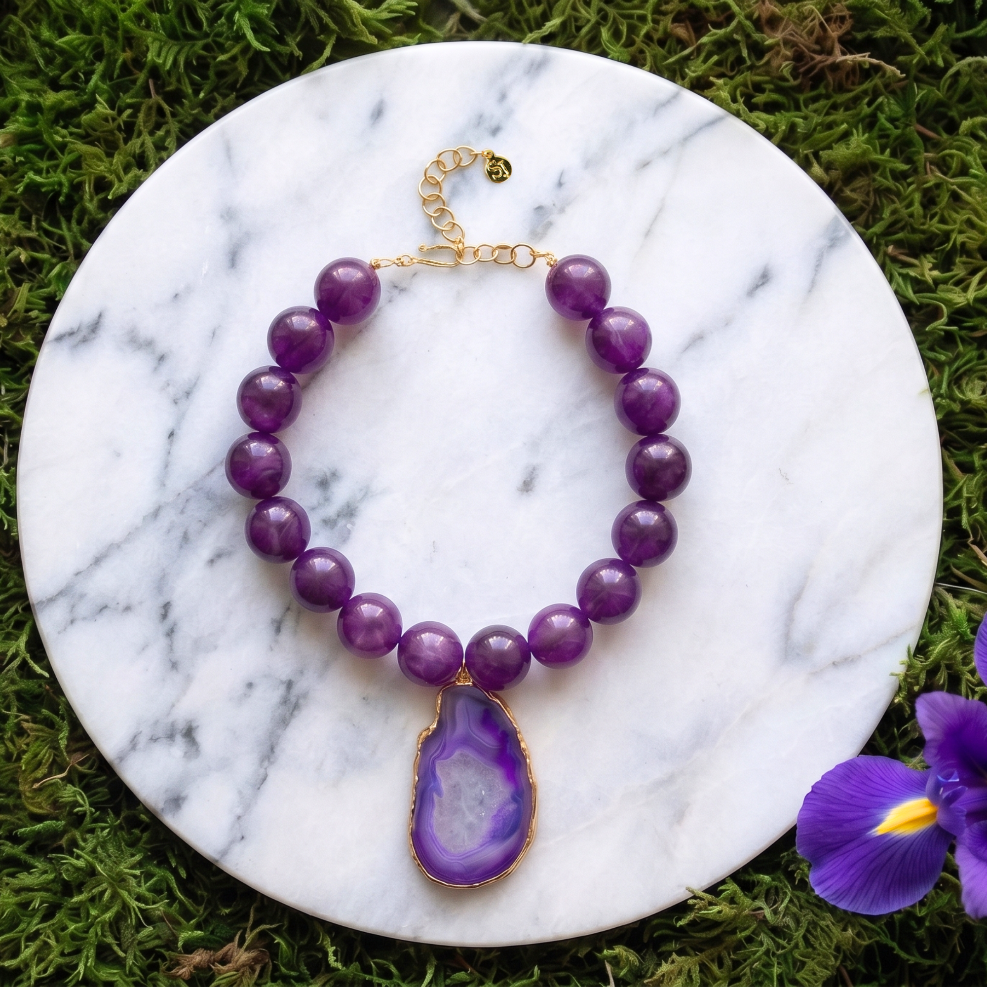 Statement necklace featuring rich grape agate beads and a natural purple druzy agate pendant edged in gold.