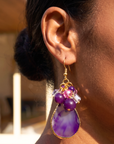 Statement dangle earrings featuring genuine purple agate slices, grape agate beads, faceted crystal accents, and gold detailing.