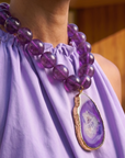 Statement necklace featuring rich grape agate beads and a natural purple druzy agate pendant edged in gold.