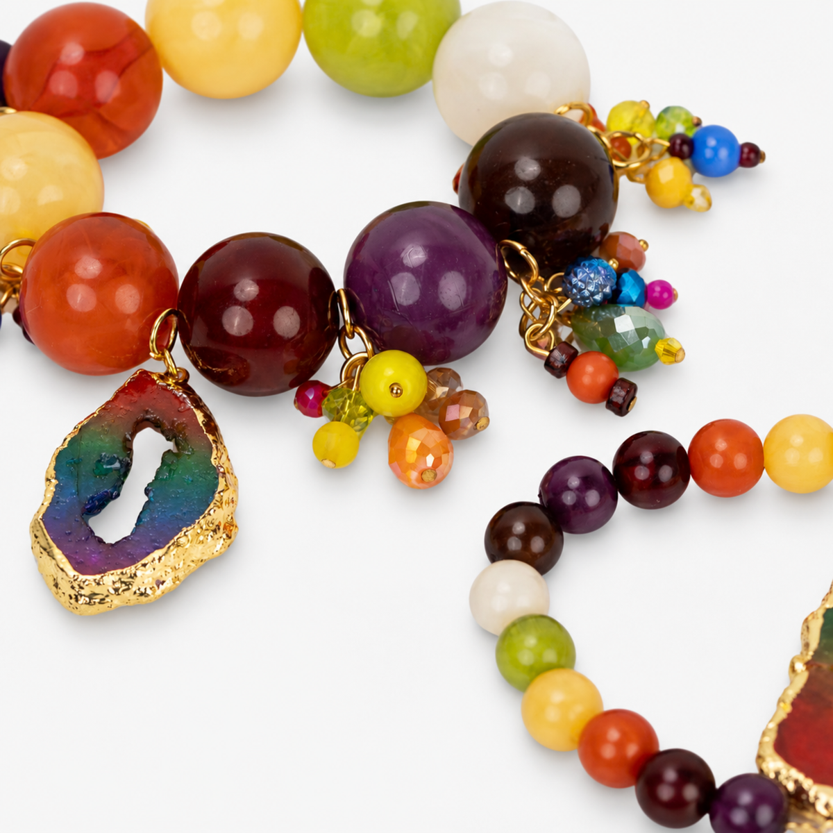 Chrysallis Joyride stretch bracelets featuring a large rainbow agate centerpiece and colorful dangling bead clusters.