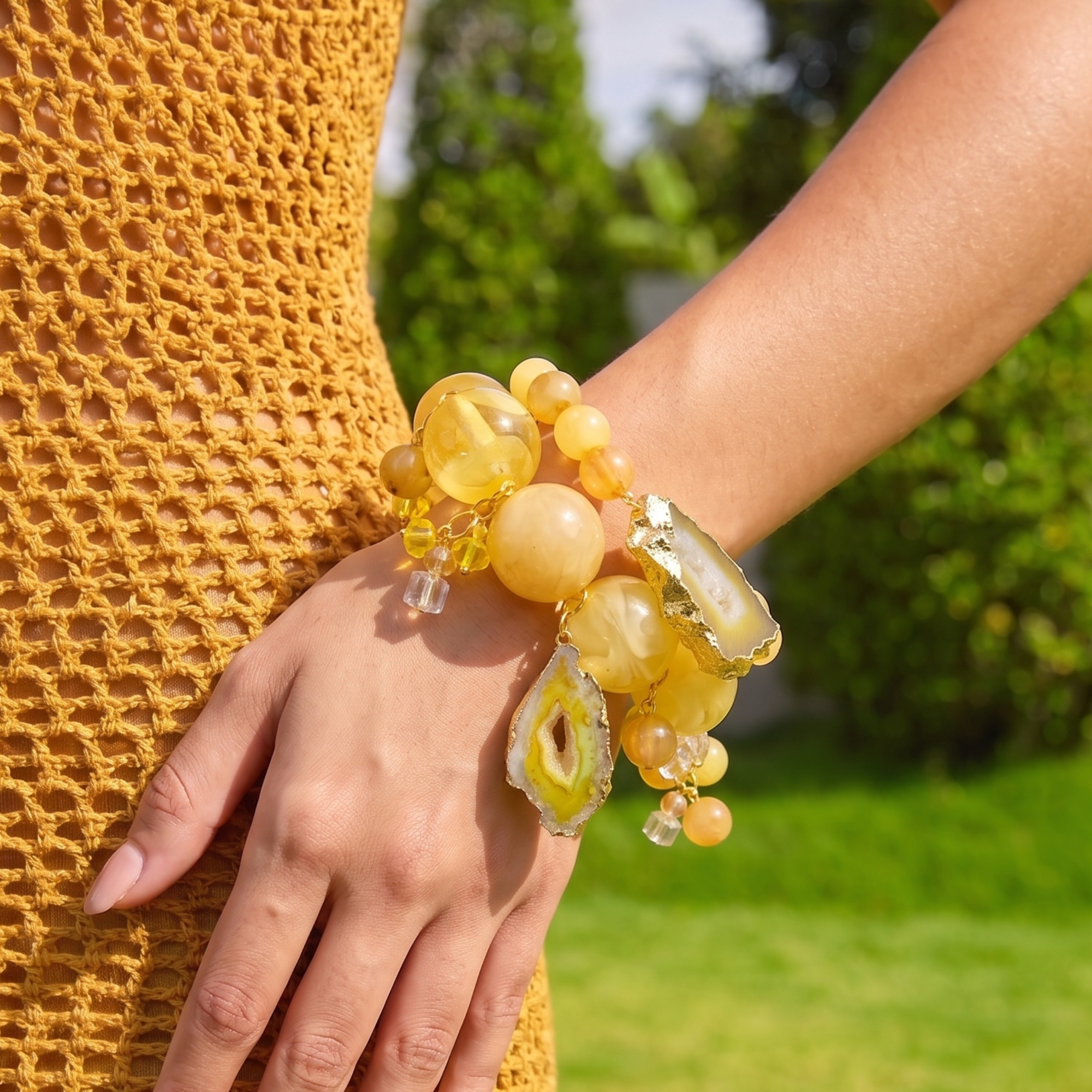 Yellow and cream marbled stretch bracelet stack featuring oversized beads, a natural agate slice pendant, and sparkling accent details by Sassy Jones.