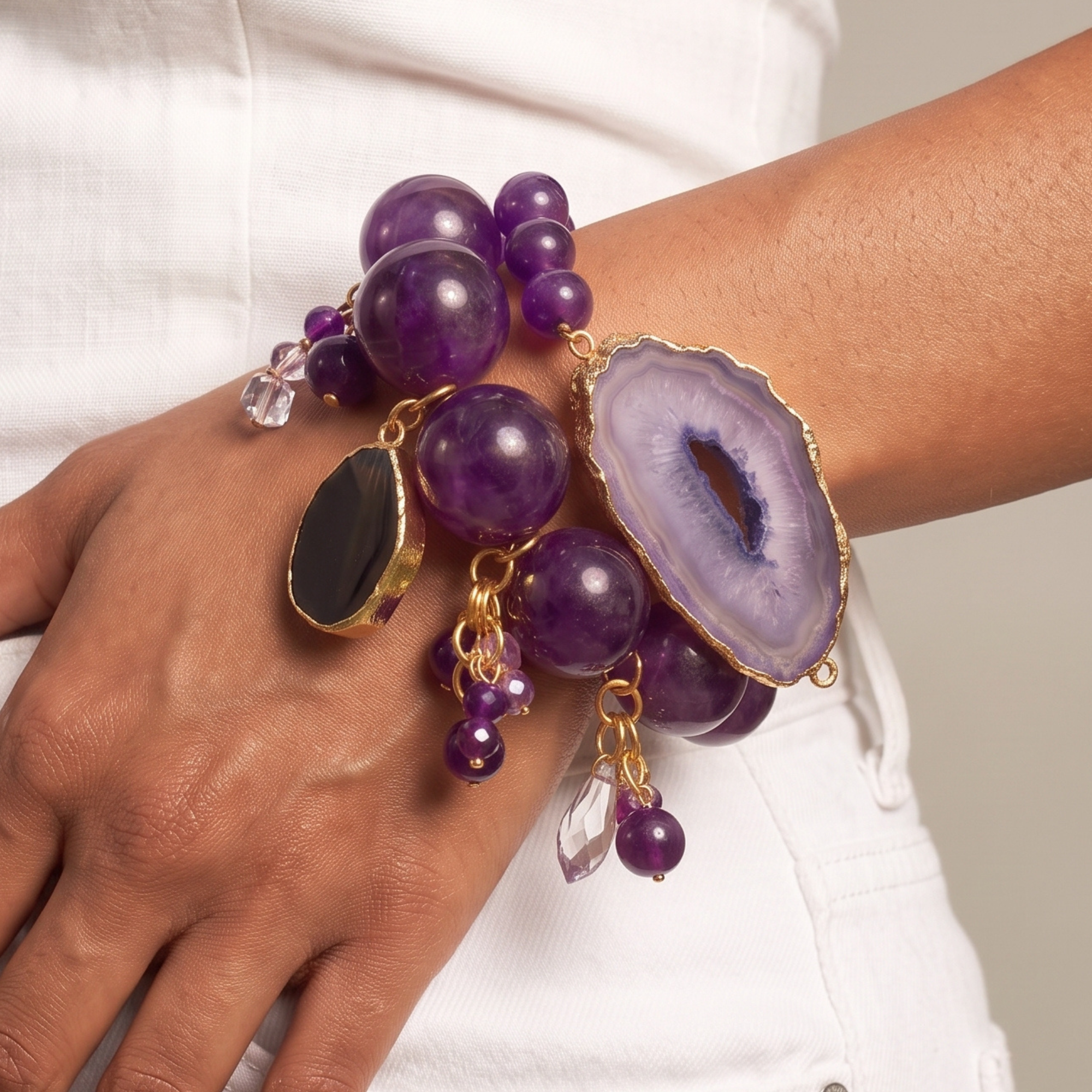 Chrysallis purple bracelet stack featuring gold-edged agate slices, purple beads and dangling accents.