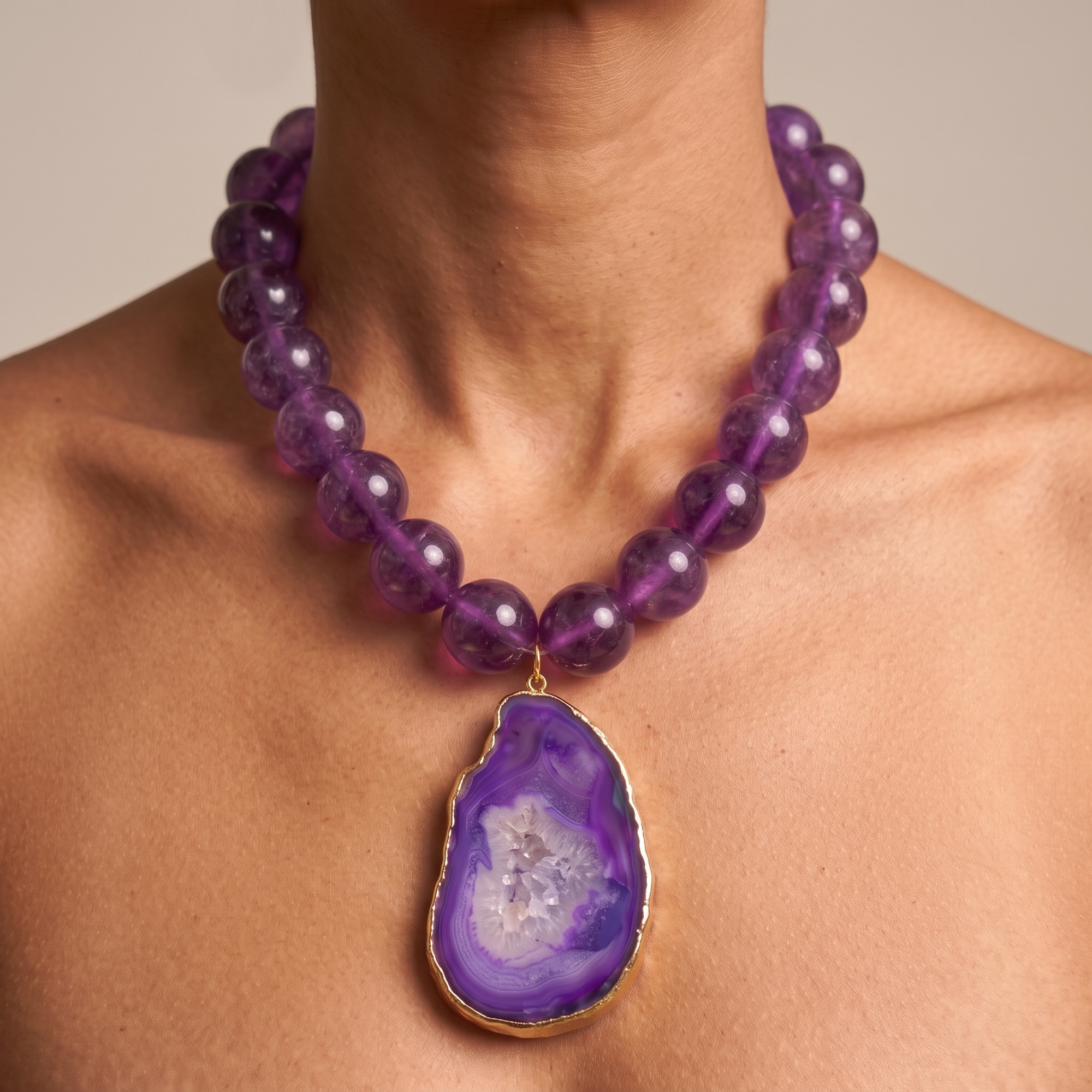 Close-up of purple agate statement necklace featuring layered violet stone patterns and sparkling druzy center.