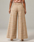 Womens high-waisted tweed trousers with dramatic wide legs and tailored front pleating.