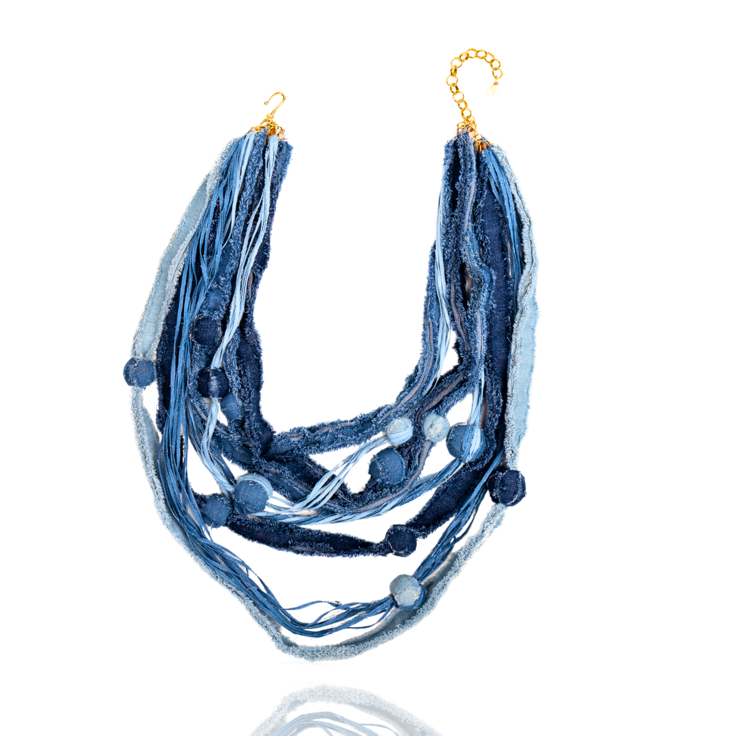 Denim necklace, Handmade multi-layered necklace with frayed denim strips and fabric balls in various shades of blue, finished with a gold chain clasp