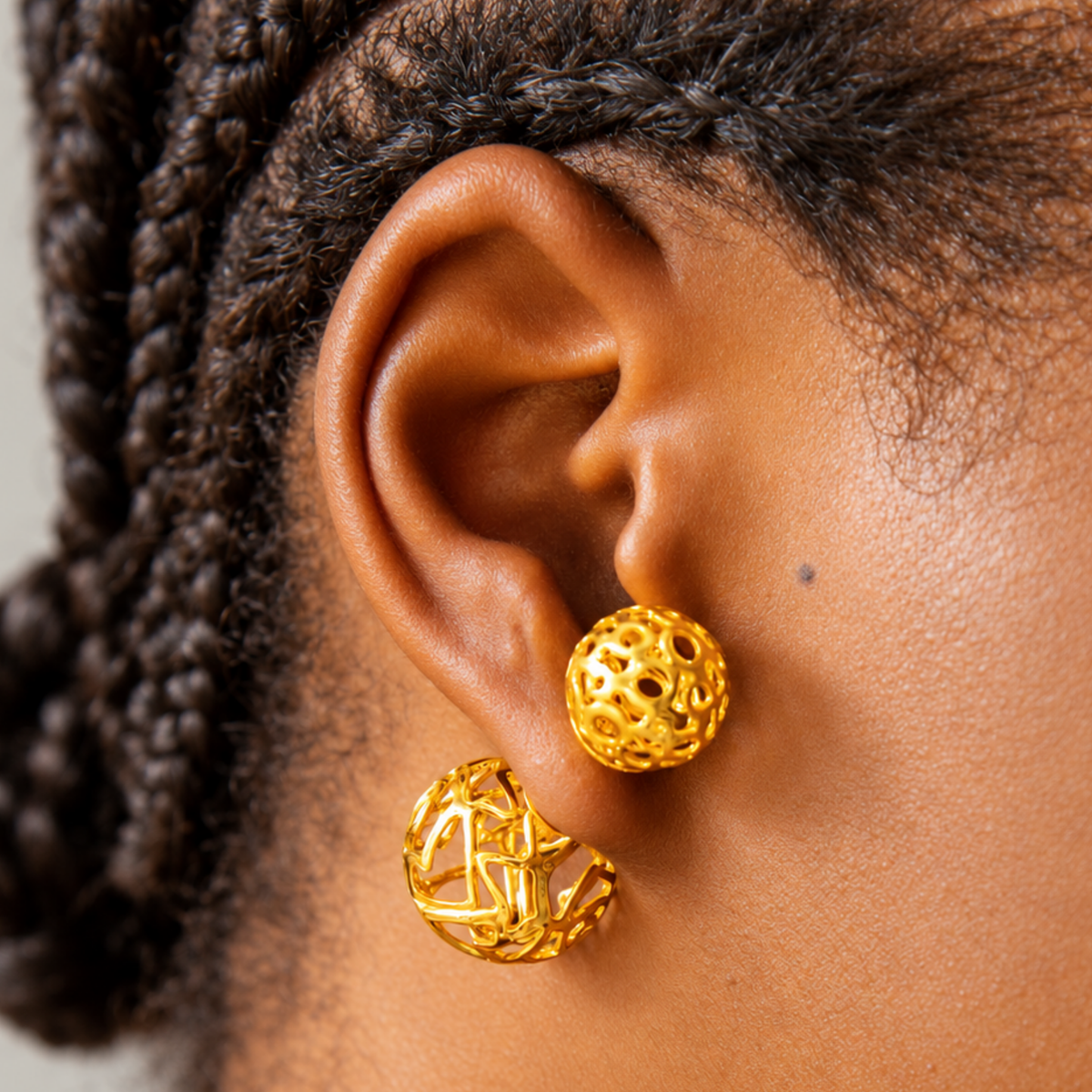 Dina Gold Openwork Sculptural Sphere Double Stud Earrings featuring two dimensional gold globes.