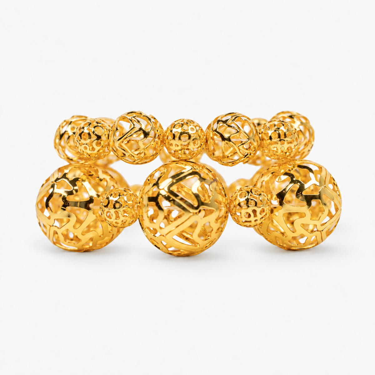 Dina Gold Openwork Sculptural Sphere 2 Piece Stretch Bracelet Stack featuring oversized and petite gold globes.