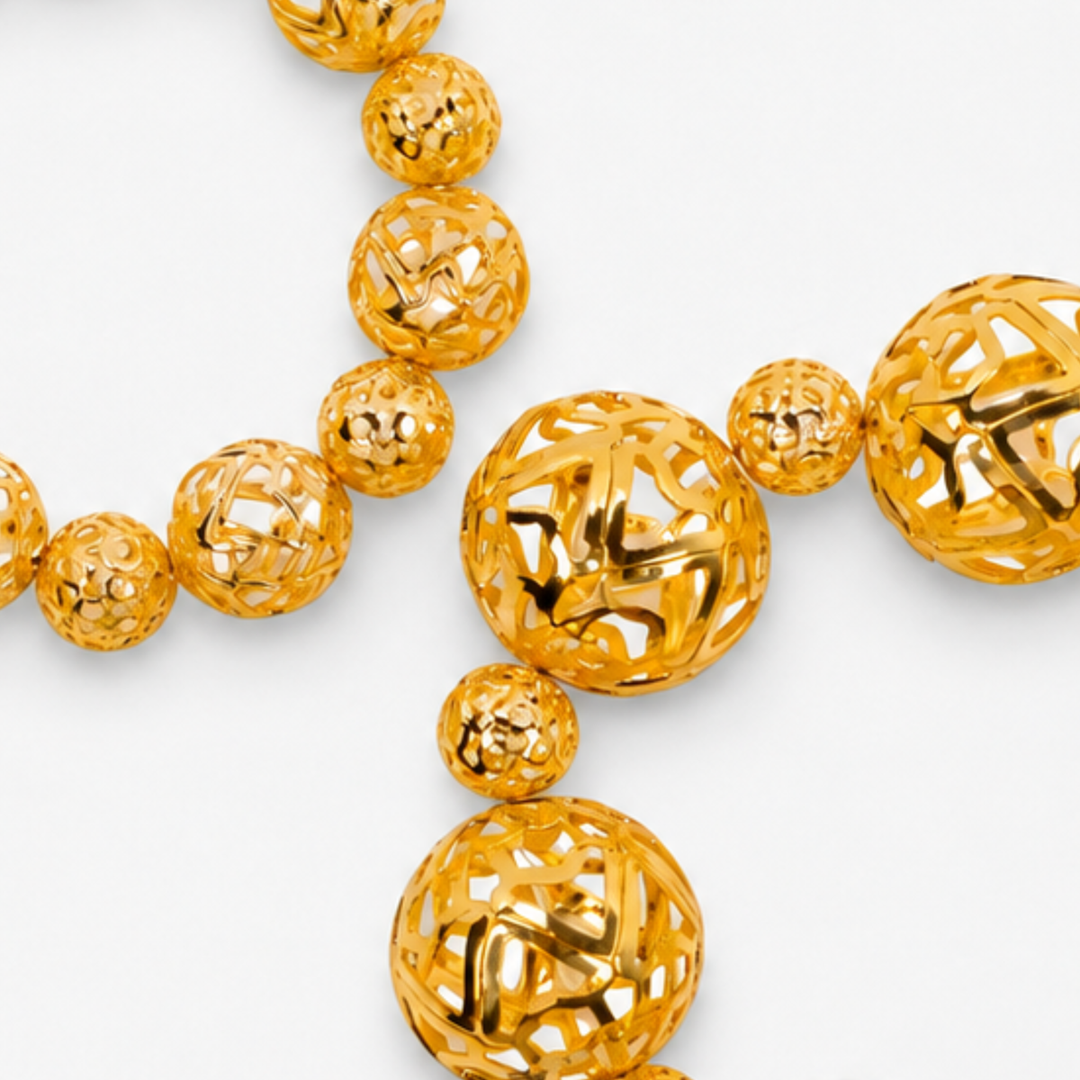 Dina Gold Openwork Sculptural Sphere 2 Piece Stretch Bracelet Stack featuring oversized and petite gold globes.