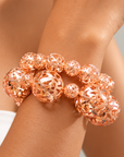 Dina Rose Gold 2 Piece Stretch Bracelet Stack featuring oversized and petite openwork sculptural spheres.