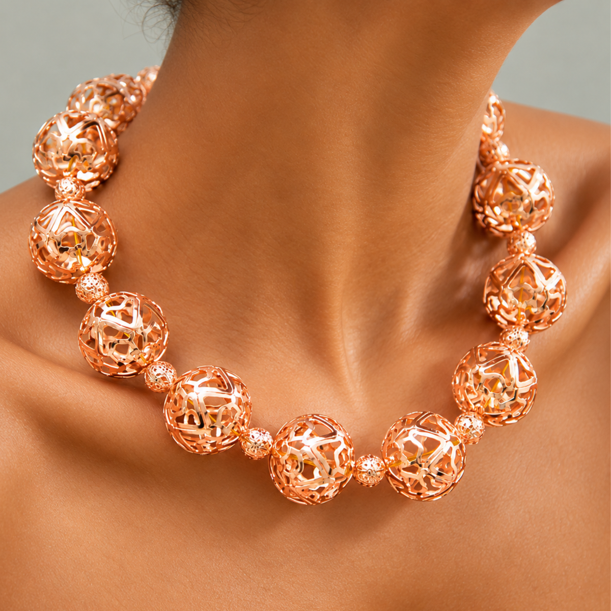 Dina Sculptural Globe Chain Rose Gold featuring oversized openwork sphere beads and smaller textured spacers.