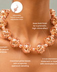 Rose gold statement necklace featuring large hollow globes with intricate sculptural cutout detailing.