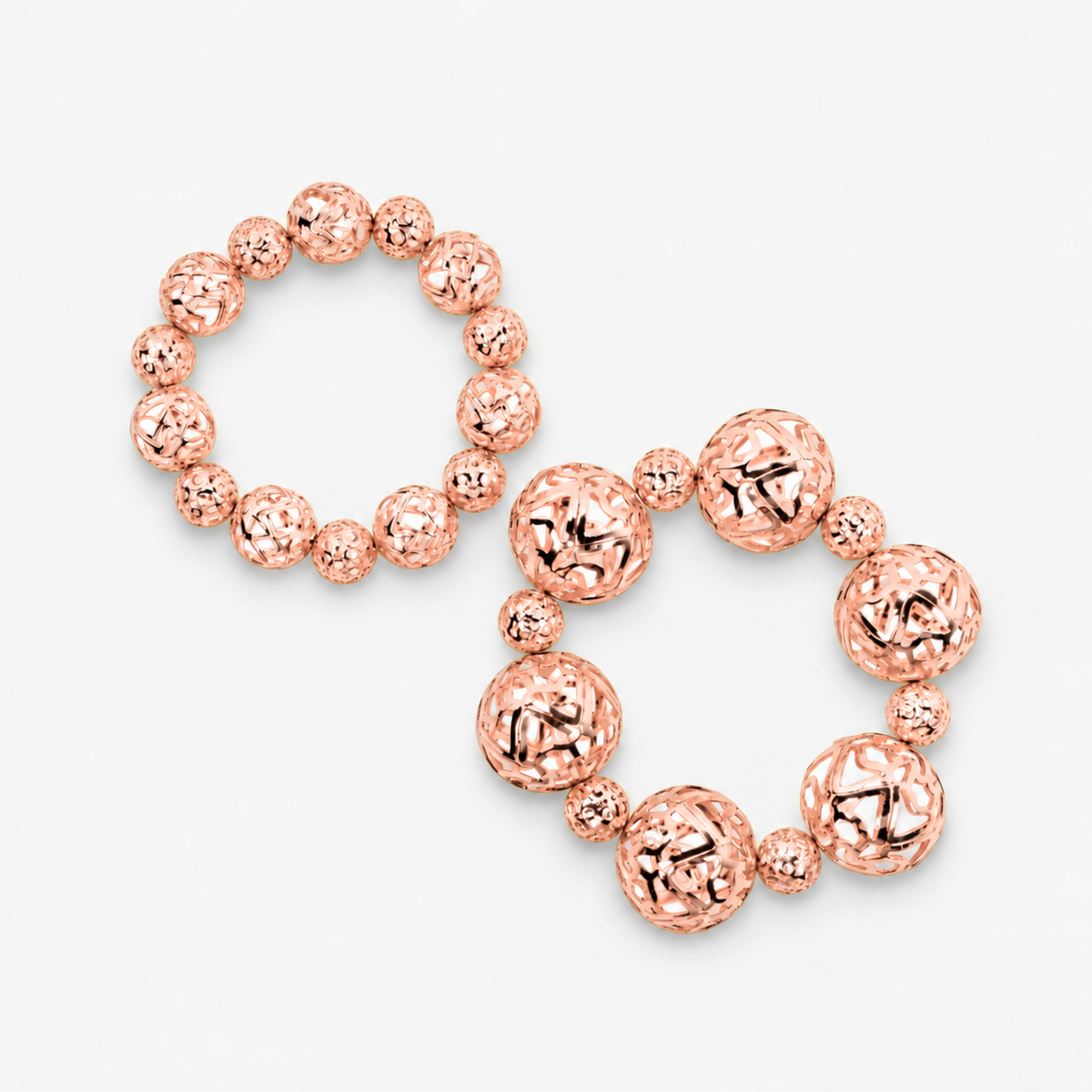 Dina Rose Gold 2 Piece Stretch Bracelet Stack featuring oversized and petite openwork sculptural spheres.