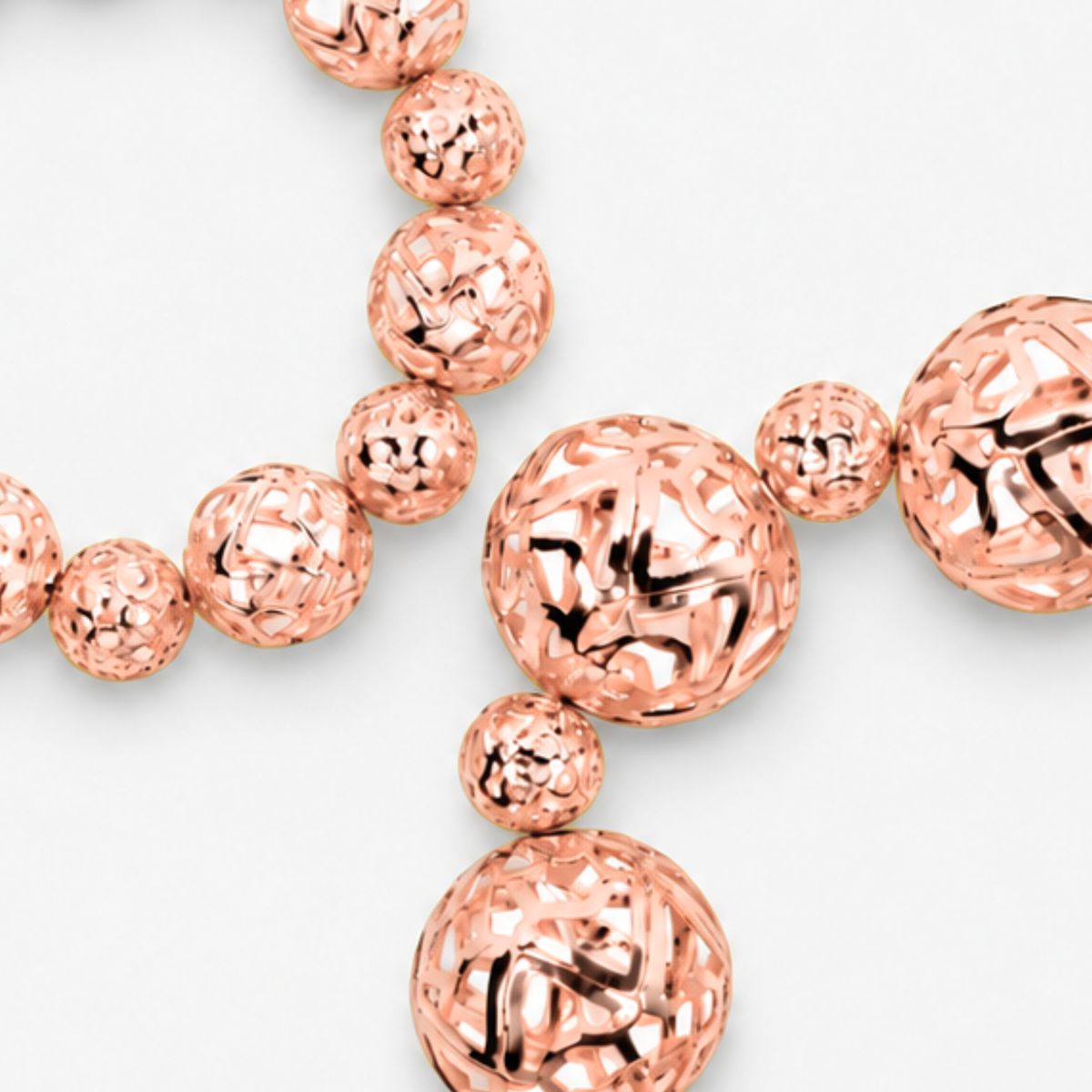Dina Rose Gold 2 Piece Stretch Bracelet Stack featuring oversized and petite openwork sculptural spheres.