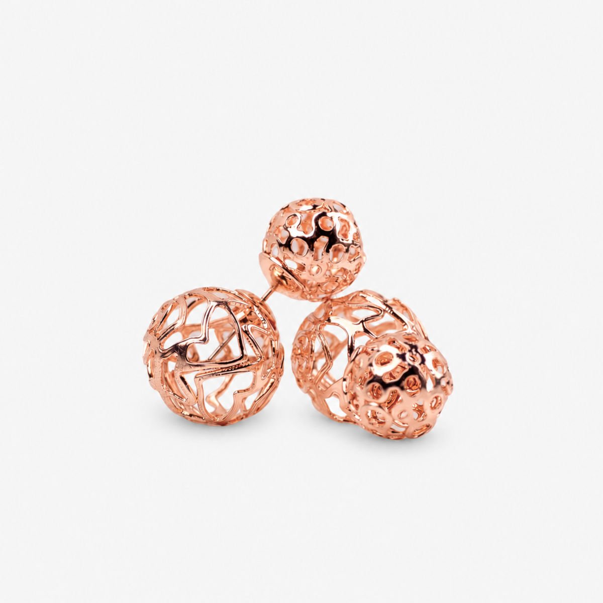 Rose gold statement earrings featuring a petite textured sphere and larger sculptural globe.