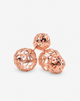 Rose gold statement earrings featuring a petite textured sphere and larger sculptural globe.