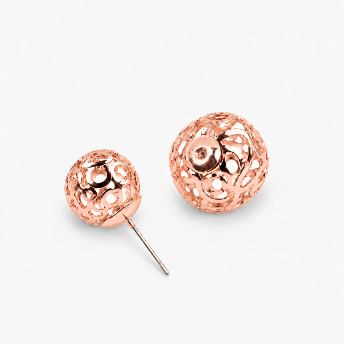 Rose gold statement earrings featuring a petite textured sphere and larger sculptural globe.