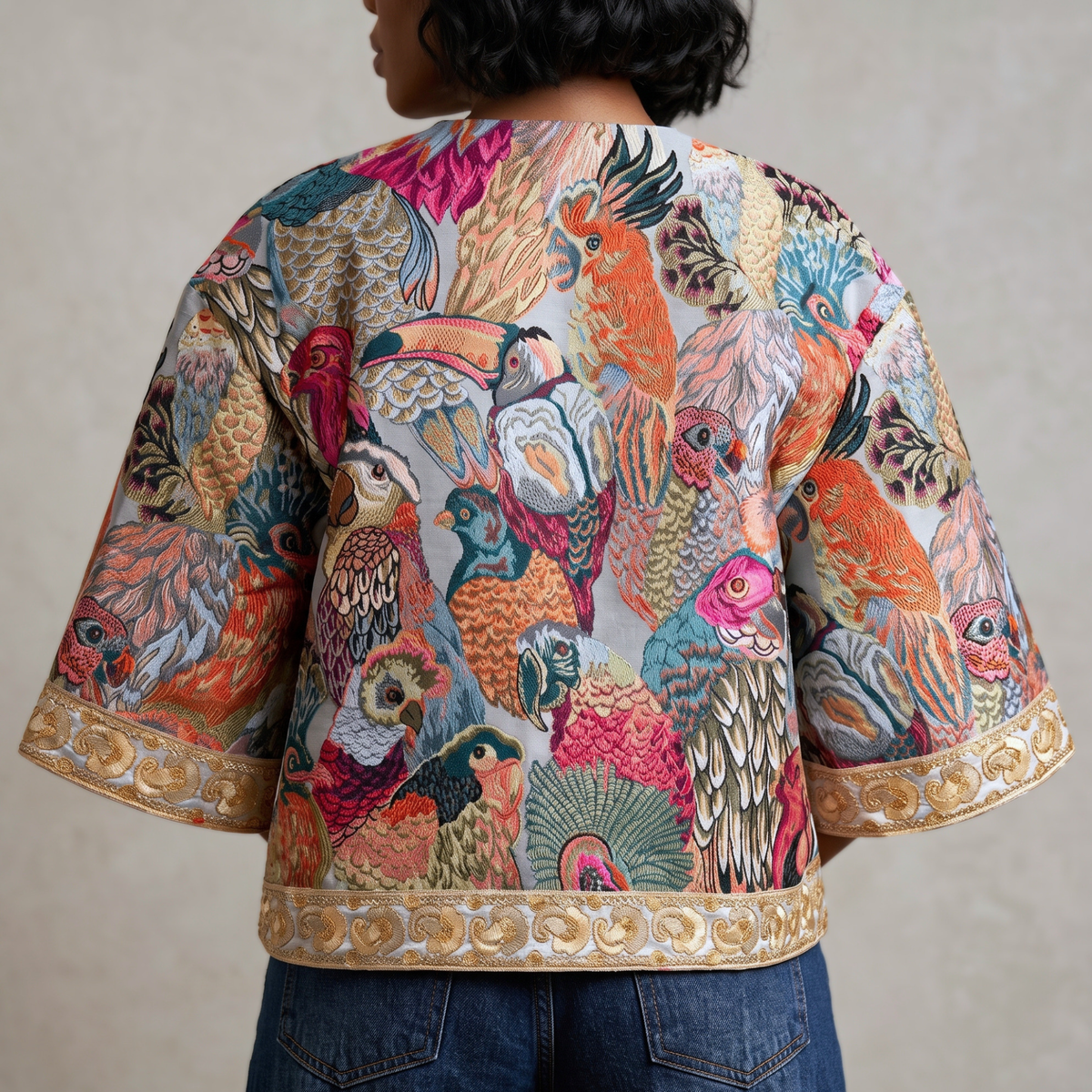 Back view of Fawna Jacquard Embroidered Jacket showcasing an allover tapestry inspired bird design in blue, coral, pink and teal.