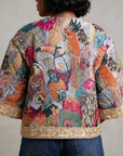 Back view of Fawna Jacquard Embroidered Jacket showcasing an allover tapestry inspired bird design in blue, coral, pink and teal.