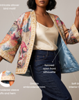 Fawna statement jacket featuring wide sleeves, ornate gold floral embroidery and a colorful allover bird motif.