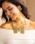 Gold butterfly statement bib necklace with champagne and clear crystals in a radiant oversized design.