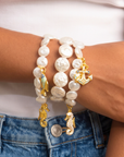 Close up of Harbor Grace Pearl Bracelet Stack showing three pearl strands with gold, blue and turquoise nautical details.