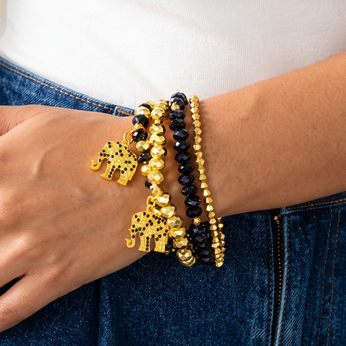 Ibiza 4pc Stretch Bracelet Stack in Black and Gold featuring faceted beads and elephant charms.