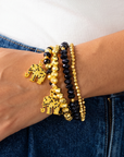 Ibiza 4pc Stretch Bracelet Stack in Black and Gold featuring faceted beads and elephant charms.