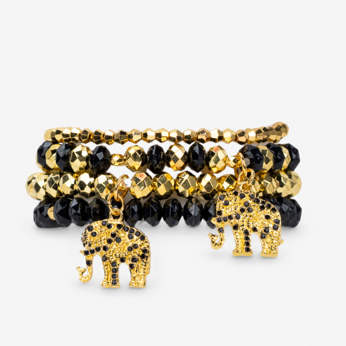 Ibiza 4pc Stretch Bracelet Stack in Black and Gold featuring faceted beads and elephant charms.