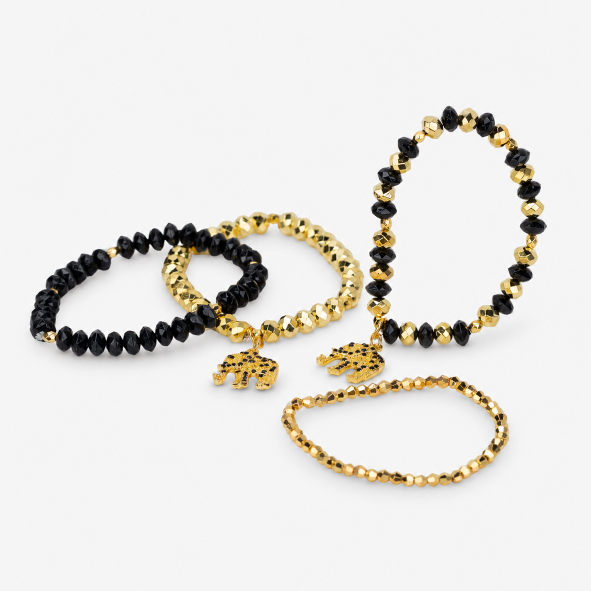 Ibiza 4pc Stretch Bracelet Stack in Black and Gold featuring faceted beads and elephant charms.