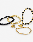 Ibiza 4pc Stretch Bracelet Stack in Black and Gold featuring faceted beads and elephant charms.