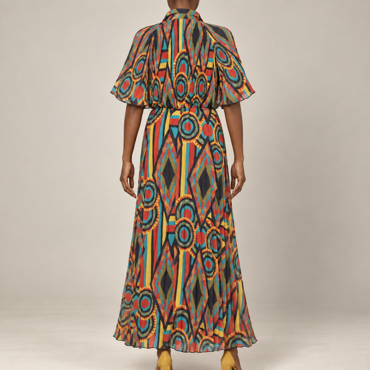 Multicolor printed maxi dress featuring cape inspired short sleeves, a fitted waist, and lightweight flowing construction.