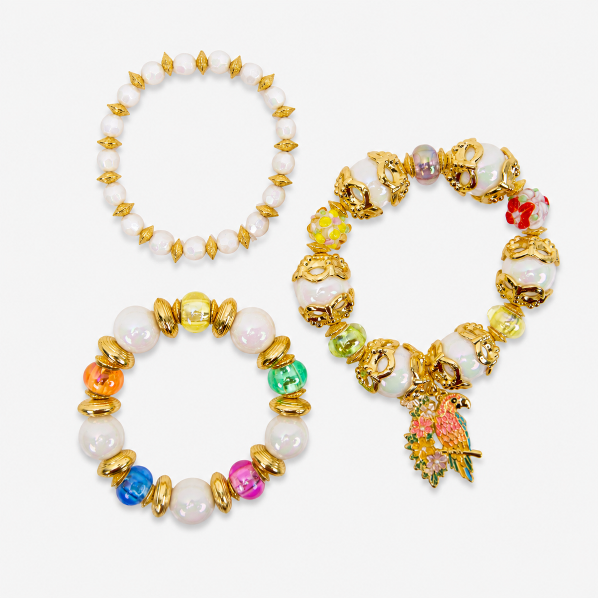 Kalani tropical parrot three piece stretch bracelet stack featuring luminous pearls, colorful beads, ornate gold tone accents and a floral parrot charm.