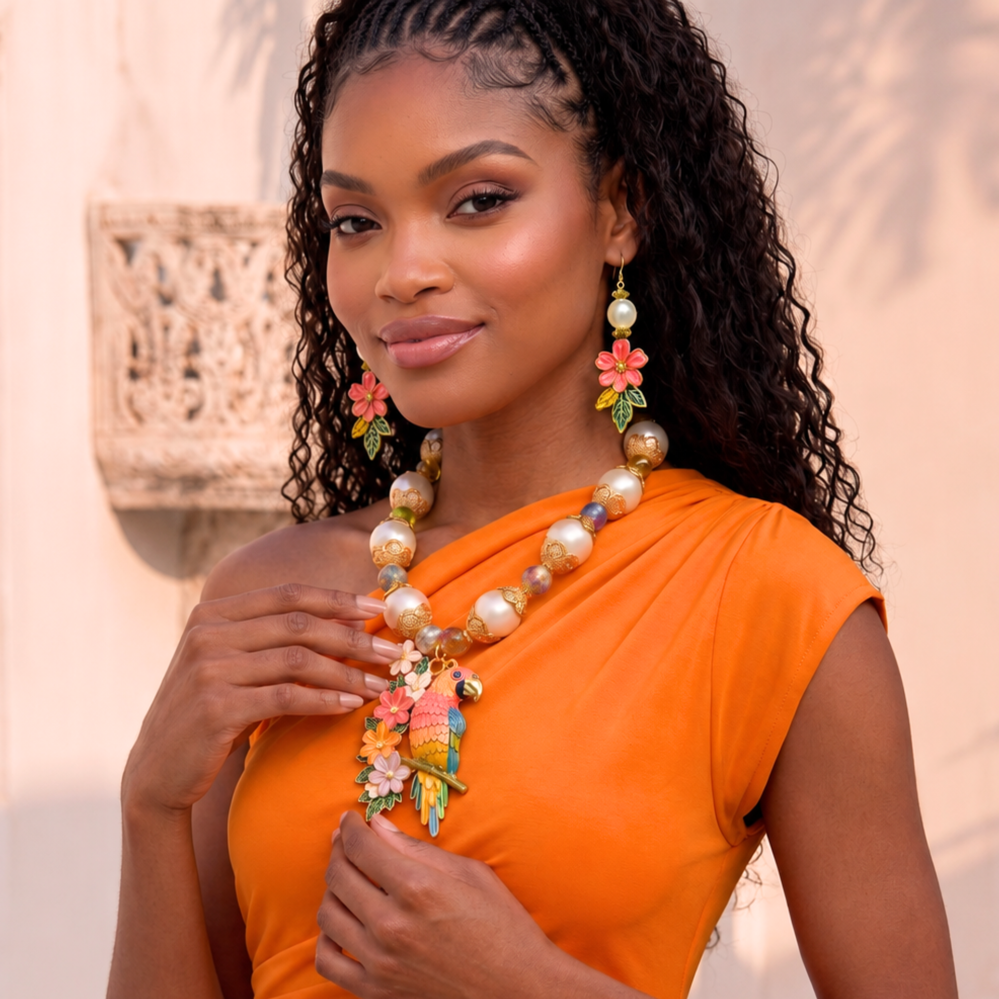 Tropical floral dangle earrings featuring luminous pearl accents, hand painted pink flowers, gold tone detailing, and lightweight drop hooks.
