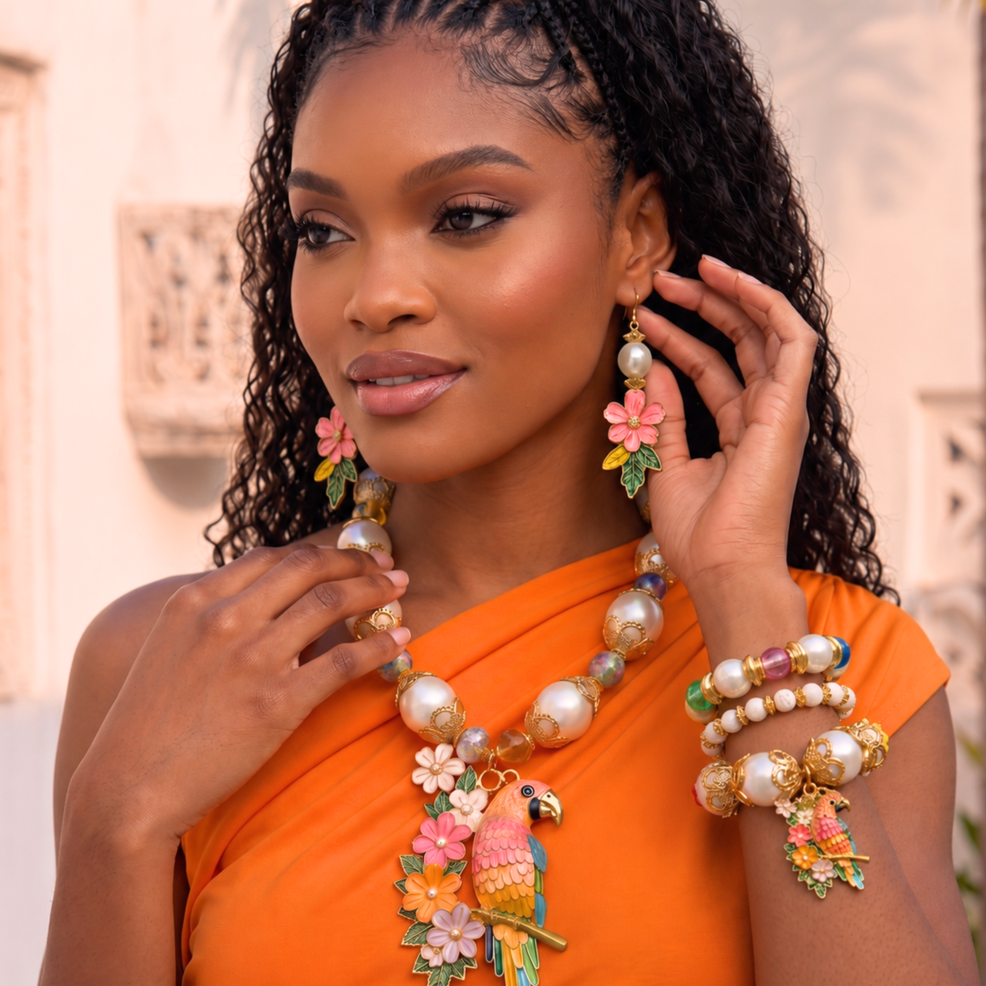 Tropical floral dangle earrings featuring luminous pearl accents, hand painted pink flowers, gold tone detailing, and lightweight drop hooks.