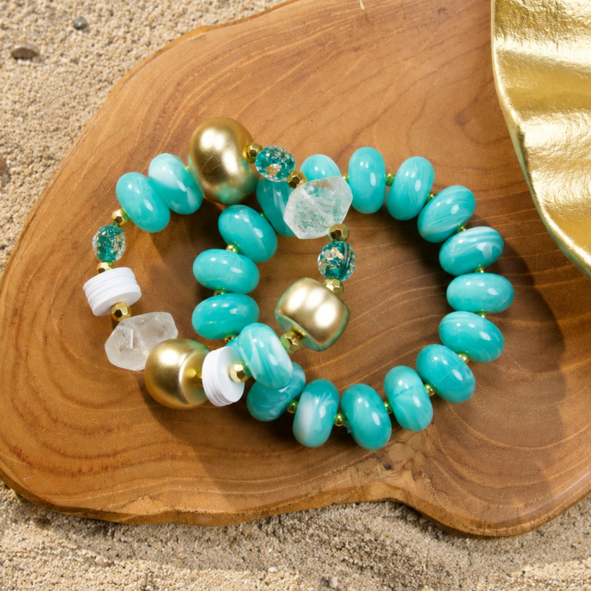 Two-piece bracelet stack featuring marbled Riviera teal beads, frosted sea-glass inspired accents, and gold-tone details by Sassy Jones.