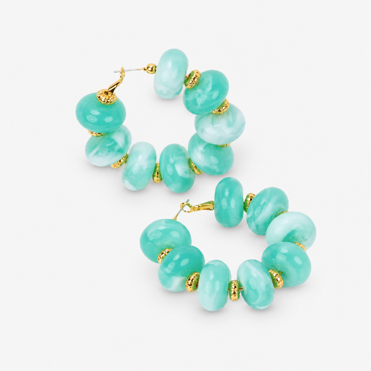 Kamaria Coconut Shell Statement Hoops in Riviera Teal featuring oversized marbled teal coconut shell pieces and gold accents.