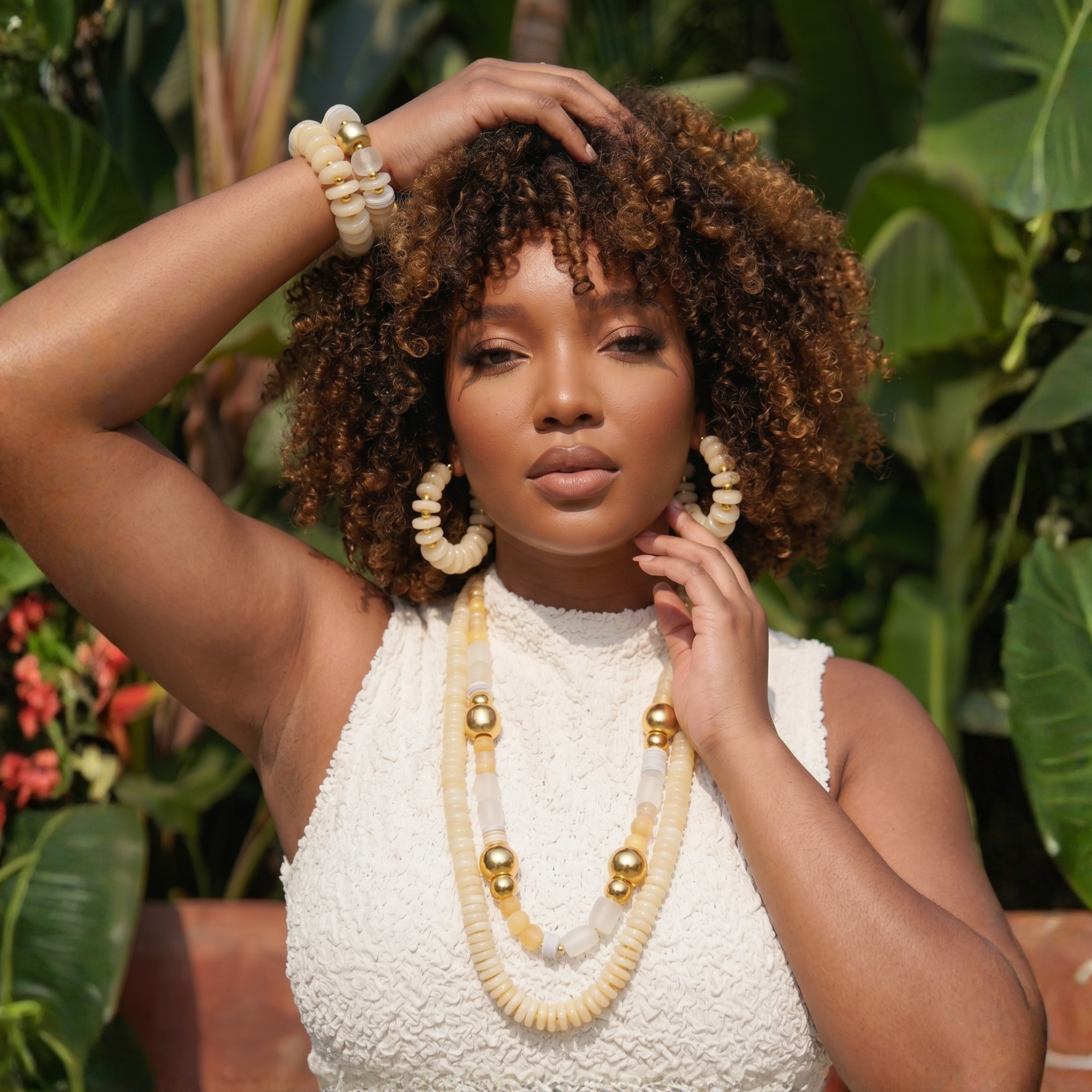 Two-piece ivory stretch bracelet stack featuring coconut-inspired beads, brushed gold accents, frosted white details, and a faceted clear focal bead.
