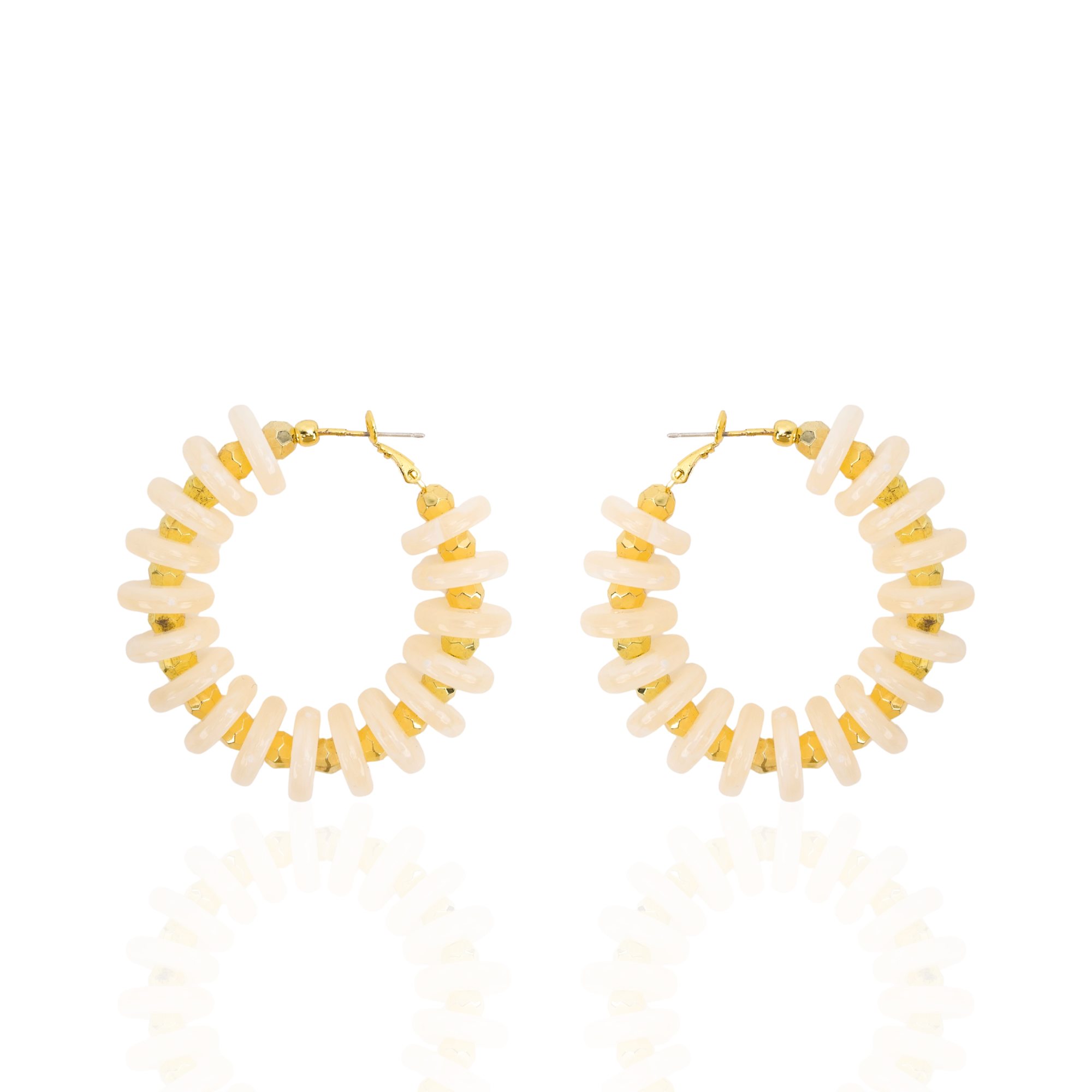 Ivory statement hoop earrings featuring smooth coconut-inspired beads with brushed gold spacers in a lightweight resort-inspired design.