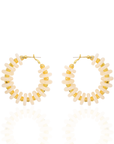 Ivory statement hoop earrings featuring smooth coconut-inspired beads with brushed gold spacers in a lightweight resort-inspired design.