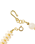 Layered ivory statement necklace featuring coconut-inspired beads, faceted clear stones, brushed gold accents, and neutral coastal styling by Sassy Jones.