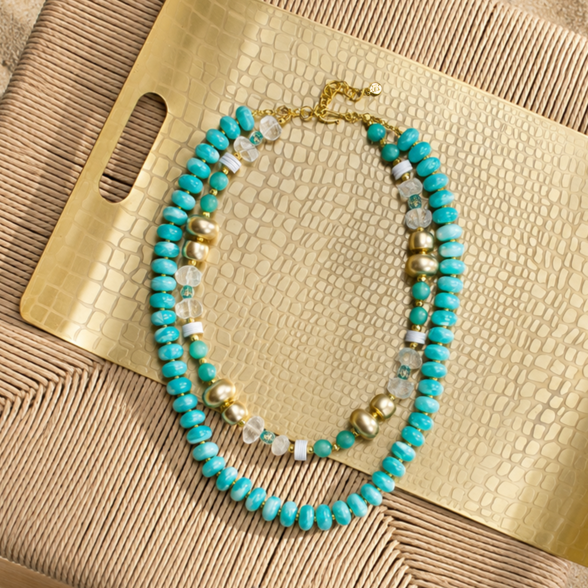 Layered teal statement necklace featuring marbled turquoise beads, frosted sea-glass inspired accents, and gold-tone details by Sassy Jones.