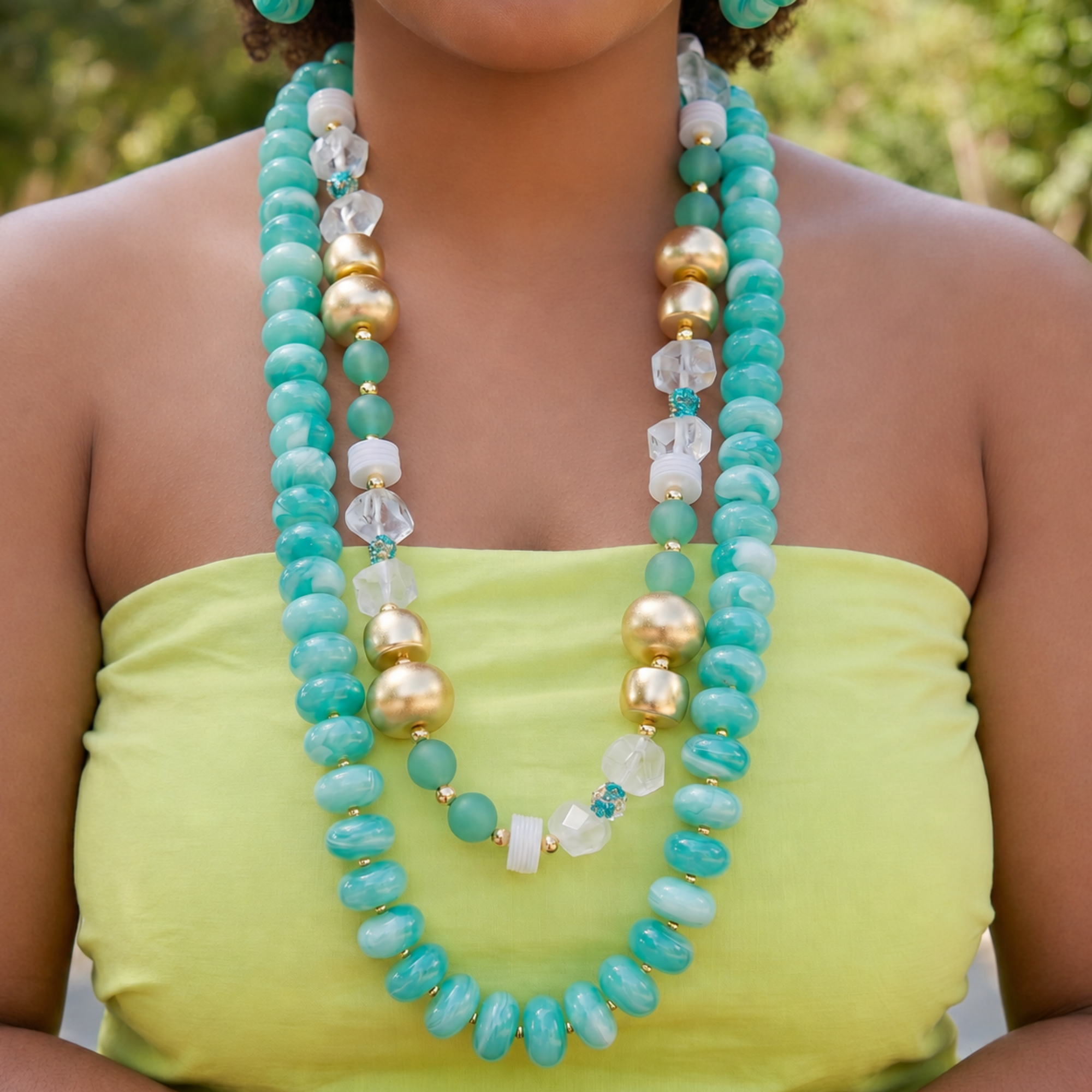 Layered teal statement necklace featuring marbled turquoise beads, frosted sea-glass inspired accents, and gold-tone details by Sassy Jones.