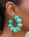 Kamaria Coconut Shell Statement Hoops in Riviera Teal featuring oversized marbled teal coconut shell pieces and gold accents.