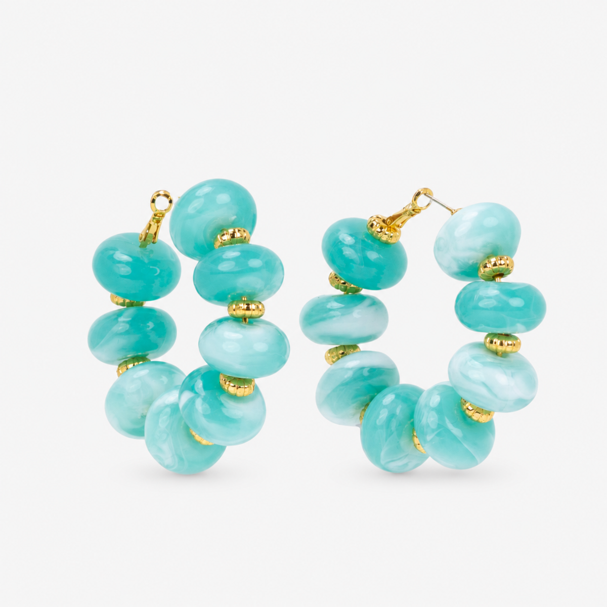 Kamaria Coconut Shell Statement Hoops in Riviera Teal featuring oversized marbled teal coconut shell pieces and gold accents.
