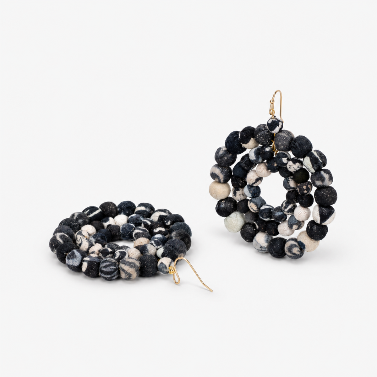 Oversized black and white statement earrings made with dimensional textile covered beads.