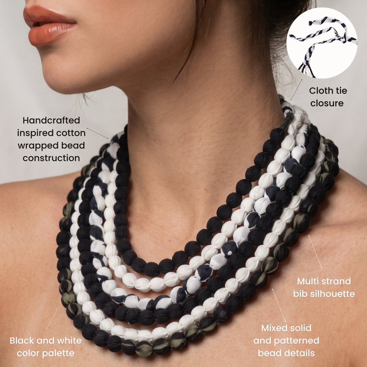 Sassy Jones Kenza necklace featuring cascading black, white and patterned fabric wrapped bead strands.